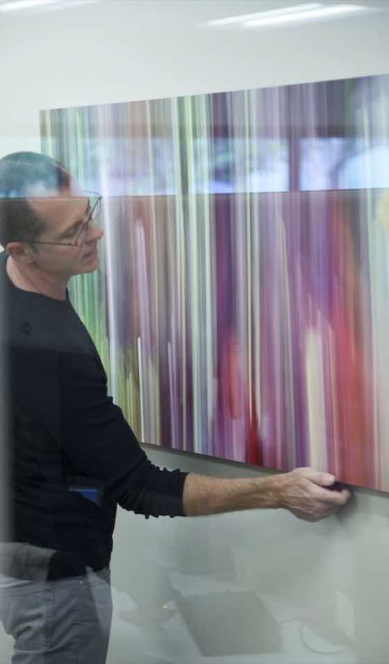 Shane Robinson installing his original fine art photography at the Andaz Maui